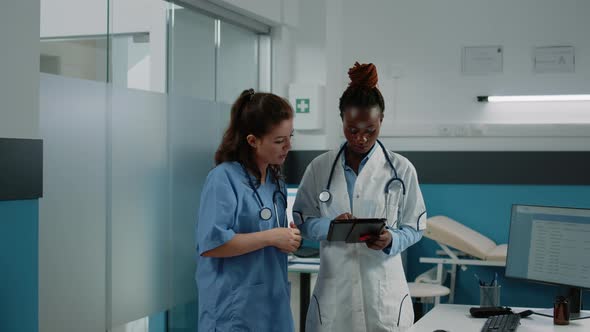 Doctor and Nurse Working with Tablet for Healthcare System