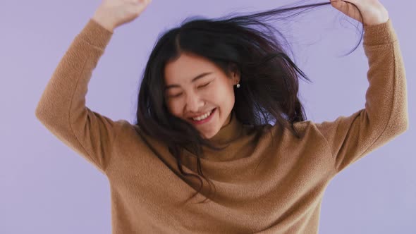 Funny Young Asian Woman in Brown Pullover