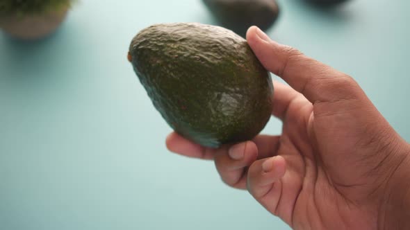 Holding Slice of Avocado Close Up  Pov