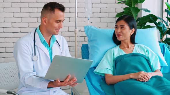 Doctor in Professional Uniform Examining Patient at Hospital