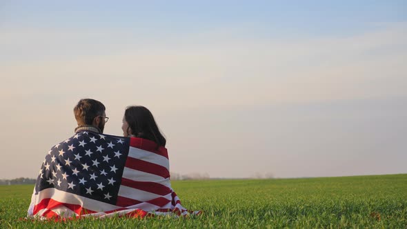 Man and Woman Wrapped By the Flag of America