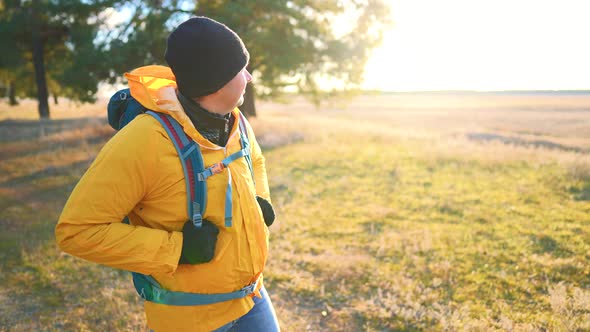 Man Backpacker Walking on Pine Forest