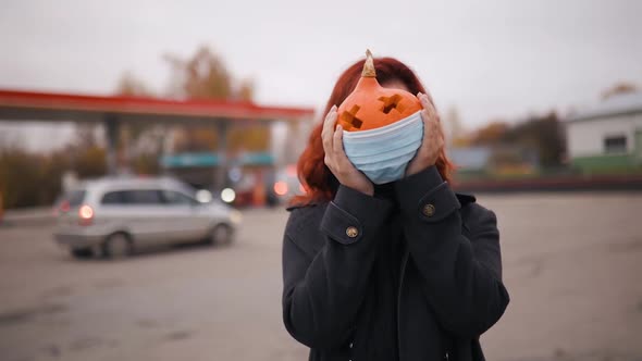 Head Swap: Hand-made Carved Pumpkin in Medical Face Mask in Woman's Hands