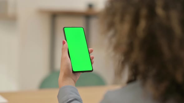 African Woman Using Smartphone with Green Chroma Key Screen