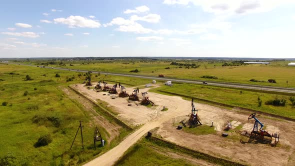 Aerial view of the row of oil derricks in summer