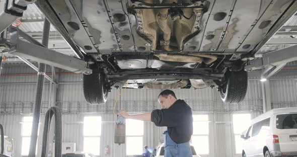 Car Auto Service Worker Cleans Tools