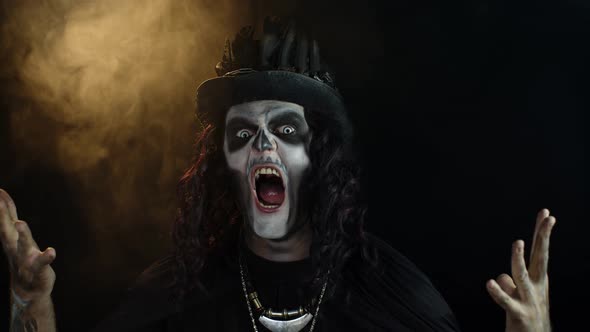 Frightening Man in Skeleton Halloween Makeup Screaming, Shouting, Making Faces, Trying To Scare
