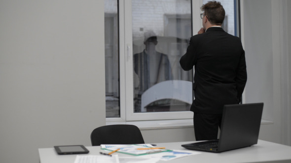 Man Thinking, Standing in Front of Window