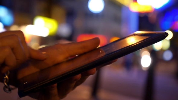 Man Hand Using Tablet In Night City
