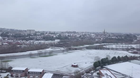 Track backwards drone shot of snowy Exeter over the River Exe