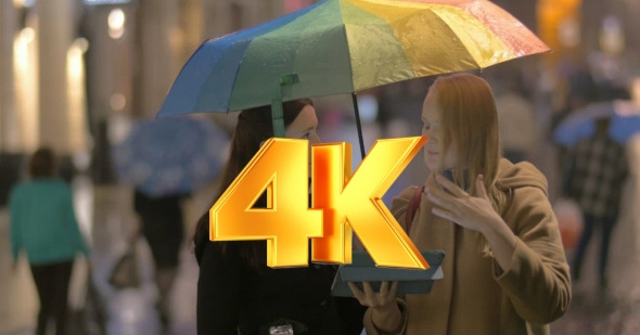 Women Talking On The Street On Rainy Day