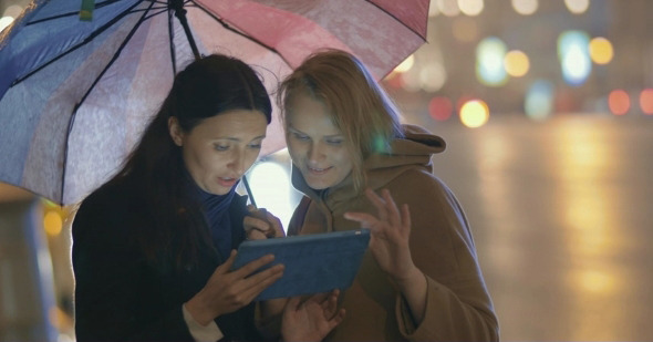 Friends Using Tablet PC Outdoors