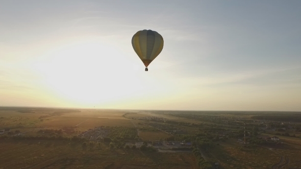 Flying a Balloon At Sunset