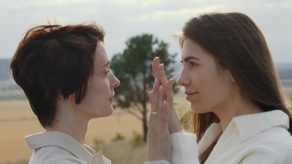 Couple of Lesbians Holding Hands and Looking on Each Other