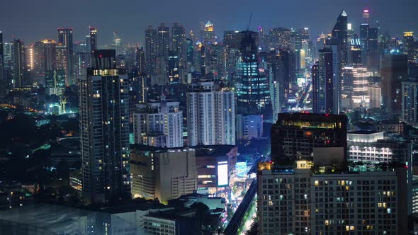 Time lapse view of business area in Bangkok, Thailand, showing buildings and traffic at night