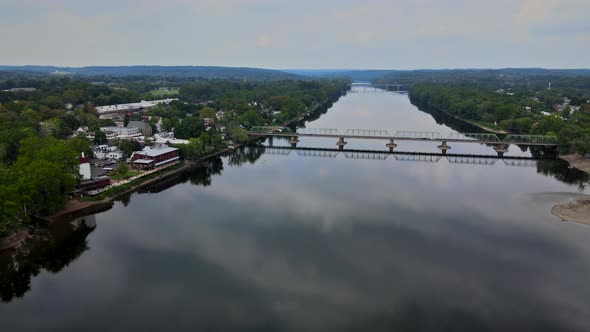 Overhead View of Delaware River on Bridge Across Aerial Landscape of Small Town with Historic City