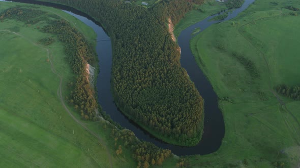 Aerial View of the River with a Rock and Forest on the Banks