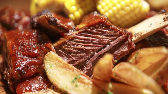 Sous vide meat prepared for dinner with grilled corn and potatoes in pub