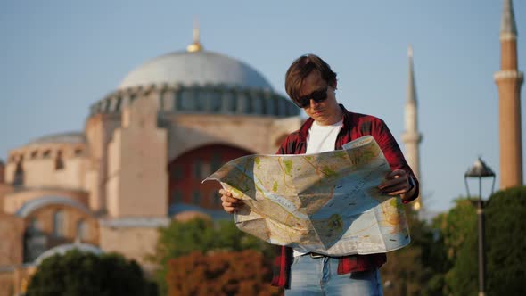 Man Tourist Looking at Map Against Ayasofya Mosque Travel Concept