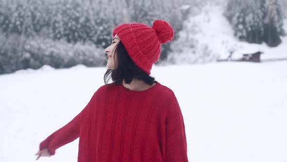 A Beautiful Smiling Girl in Winter in Slow Motion