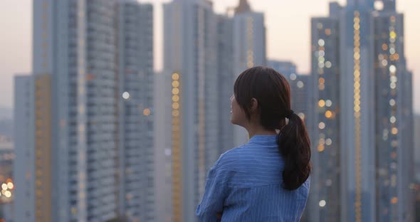 Woman Look at The Apartment Building in City