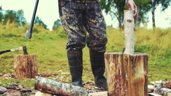 Man Chopping Wood Outdoors With Axe Cleaver