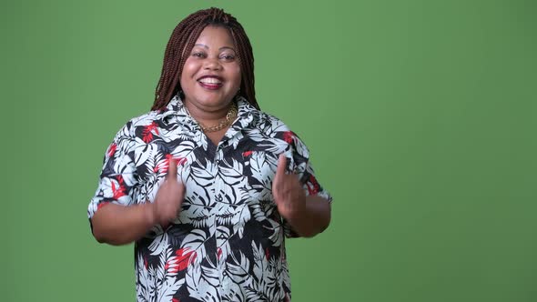 Overweight Beautiful African Woman Against Green Background