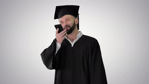 Mature Man Graduate Student Making Speakerphone Call on Gradient Background.