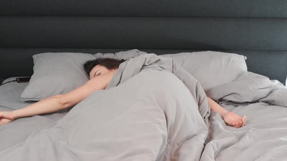 Timelapse of female sleeping on empty bed. 