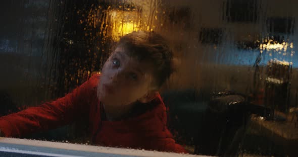 Wheelchaired Boy Watching Storm From Room