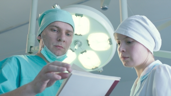 Surgeon Gives Instructions To Nurse