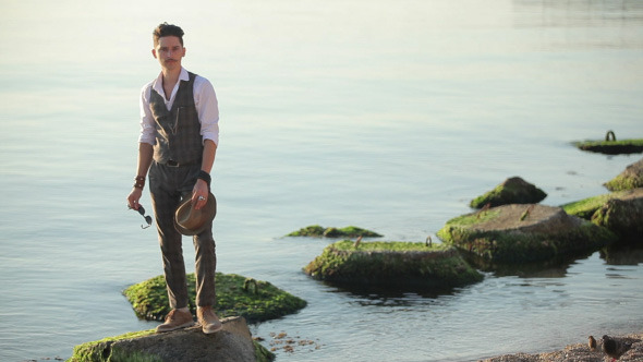 Stylish Young Man Posing On The Rocks