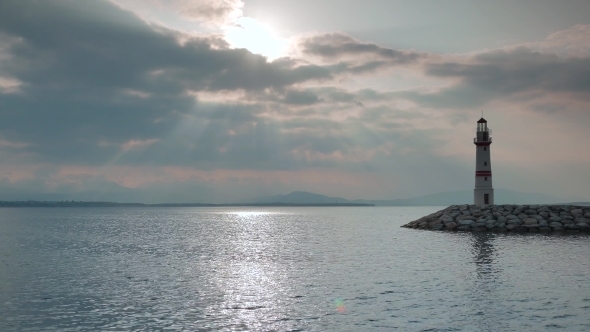 Lighthouse On a Sea Coast Under The Sun Rays And