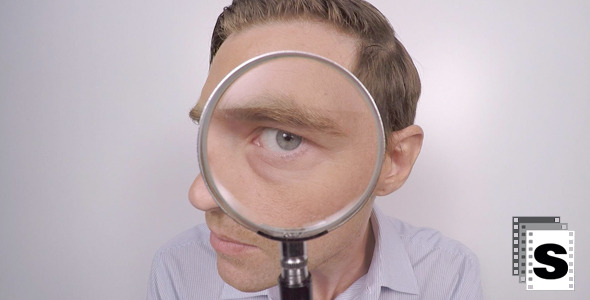 Businessman Looking Though Magnifying Glass