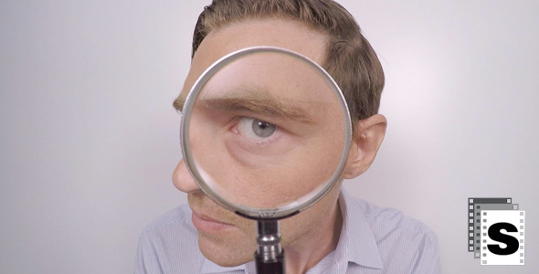 Businessman Looking Though Magnifying Glass alt