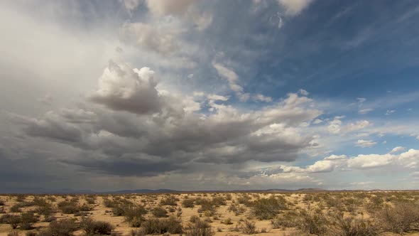 Timelapse of dark storm clouds gathering in Mojave Desert grasslands