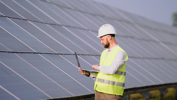 Engineer Working Use Laptop Stand Near Solar Batteries Construction Renewable Power Worker Man