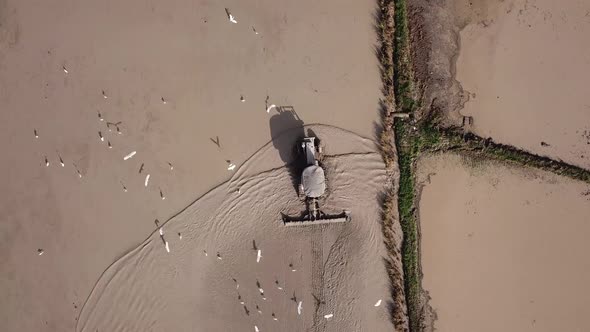 Aerial tractor prepare paddy for cultivation at Malaysia