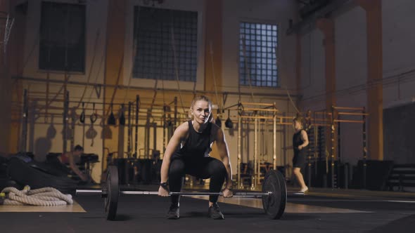 Sporty Woman Doing Barbell Snatch