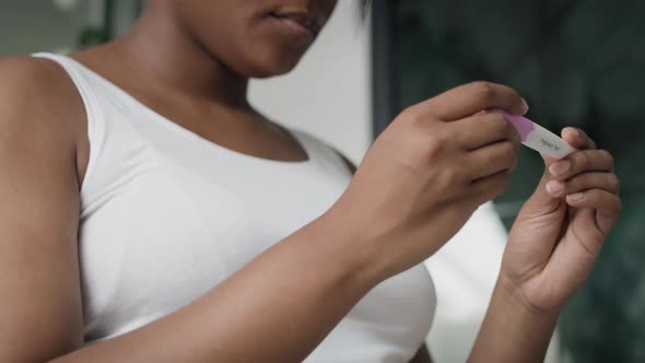 Low angle view of African-American stressed woman  waiting for pregnancy test results. Shot with RED