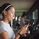 Attractive Young Mixed Race Girl Using Fitness App on Mobile Phone in the Gym - VideoHive Item for Sale