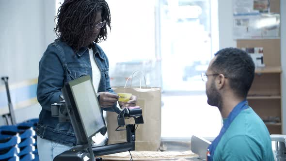 Smiling Woman Paying with Credit Card and Packing Food