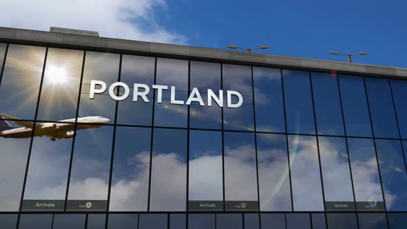 Airplane landing at Portland Oregon, USA airport mirrored in terminal