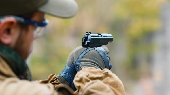 The Player Fires a BB Gun. Airsoft Game