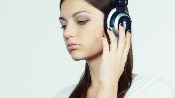 Dark-haired Girl With Headphones In The Flirting