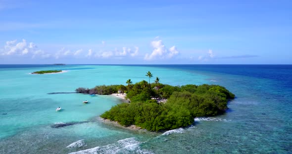 Daytime drone tourism shot of a sunshine white sandy paradise beach and aqua blue ocean background i