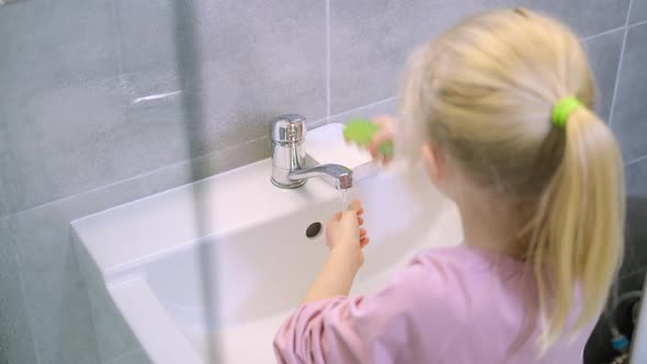 Child Blonde Girl Washing Hands with Green Soap in Modern Bathroom