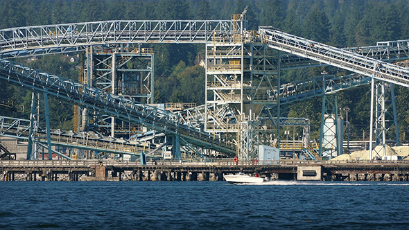 Speedboat Rides Past Refinery On Warm Day alt