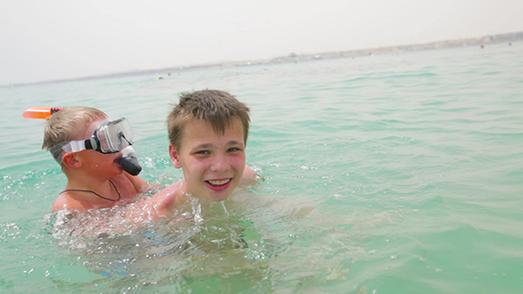 Two Boys Are Playing In The Sea