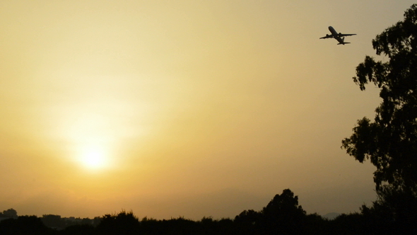 Airplane Taking Off at Sunset